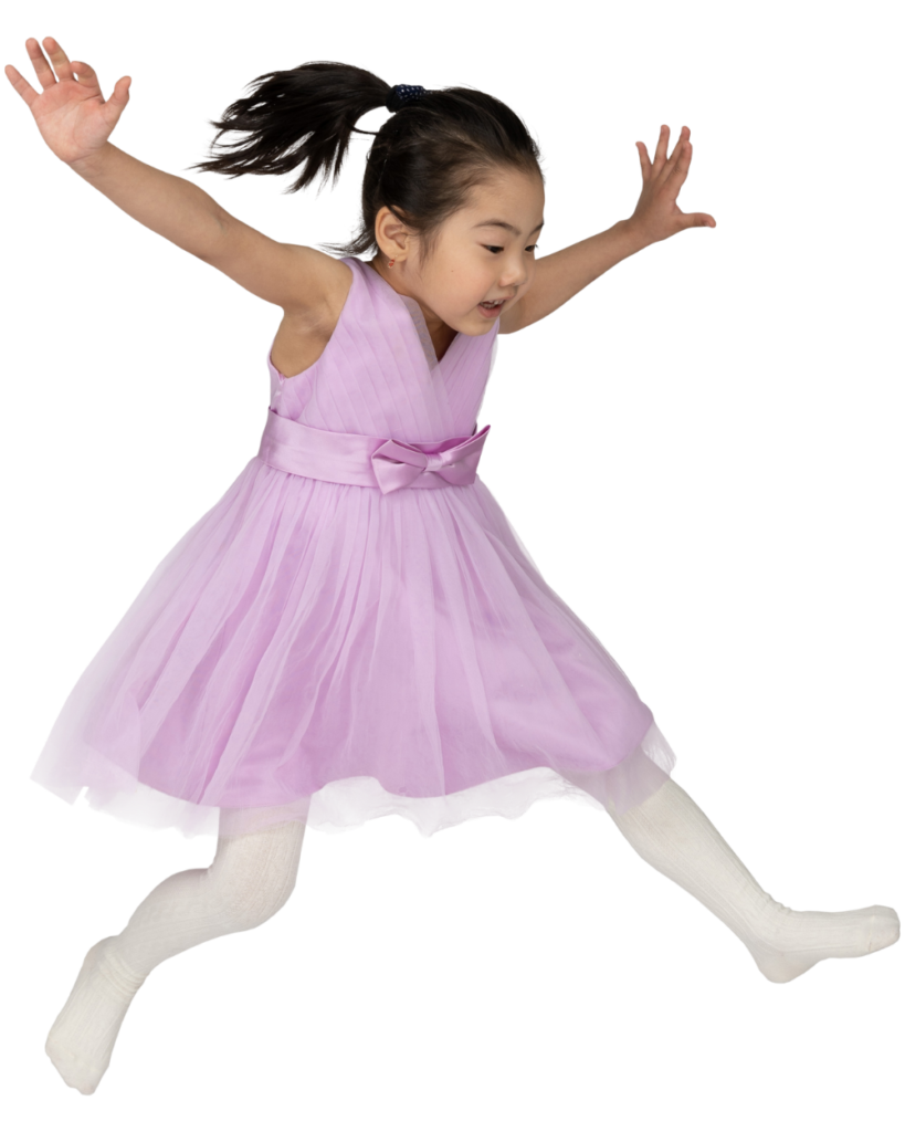 A girl in a ballerina dress jumping