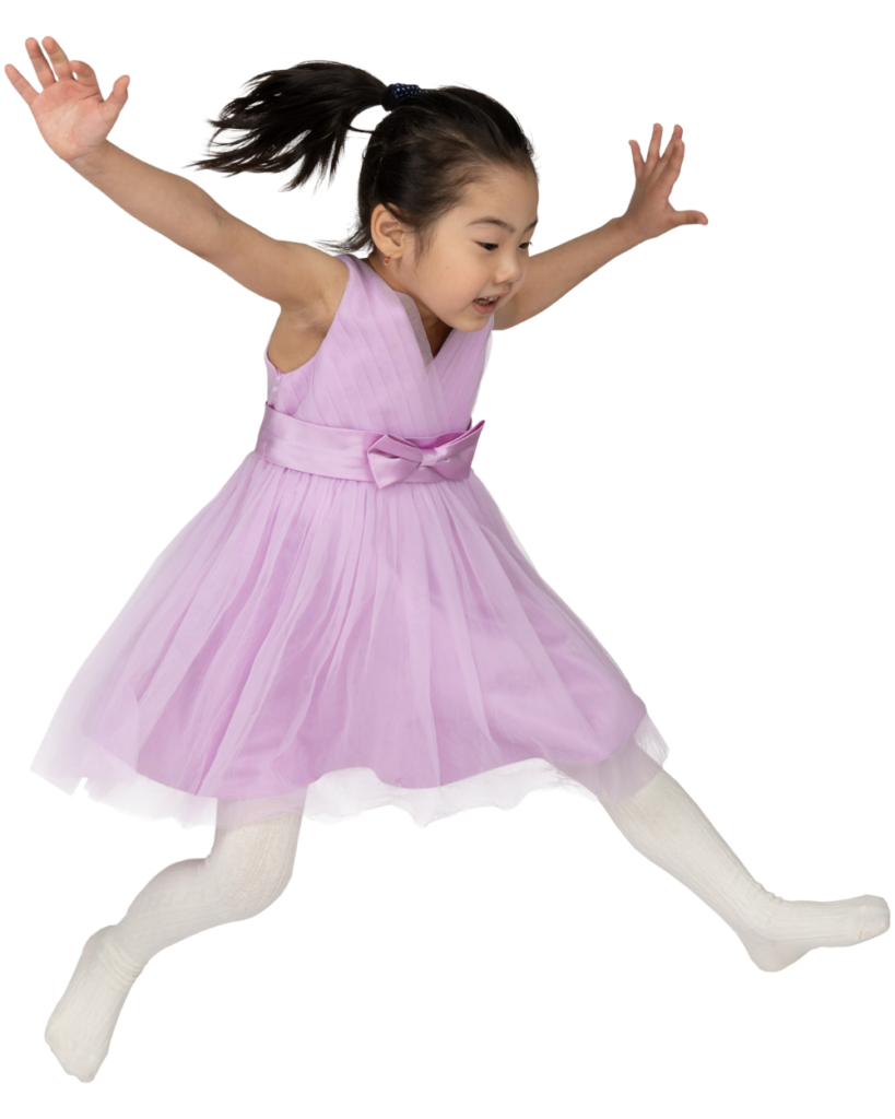 A girl in a ballerina dress jumping